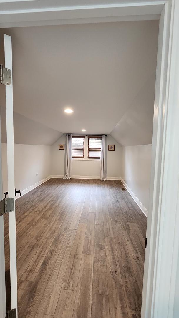 3039 S Kolin Ave, Chicago, IL 60623 - bonus room featuring dark wood-style flooring and vaulted ceiling