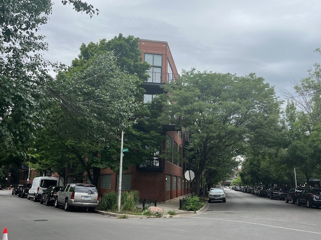 2210 W Wabansia Ave Unit 302, Chicago, IL 60647 - view of asphalt road featuring traffic signs and curbs