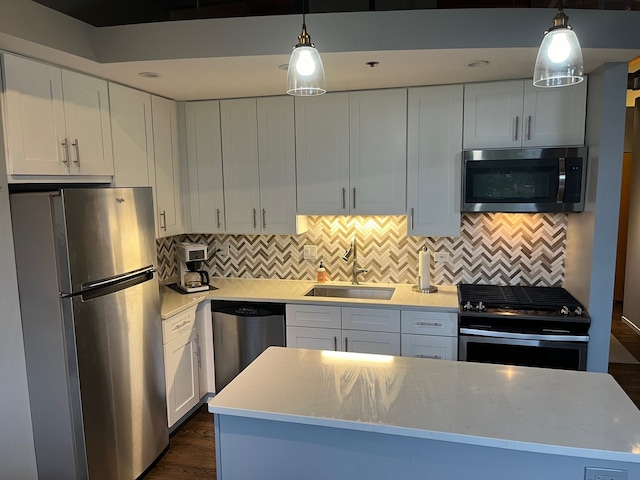 2210 W Wabansia Ave Unit 302, Chicago, IL 60647 - kitchen with stainless steel appliances, backsplash, white cabinetry, decorative light fixtures, and dark wood-type flooring