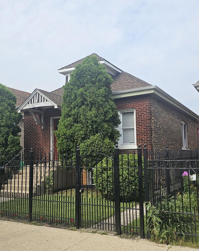 5330 S California Ave, Chicago, IL 60632 - view of front of home with brick siding, a fenced front yard, and a shingled roof