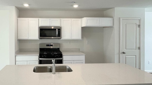 6550 Linden Trl Unit E, Wonder Lake, IL 60097 - kitchen with stainless steel appliances, white cabinetry, recessed lighting, and light stone countertops