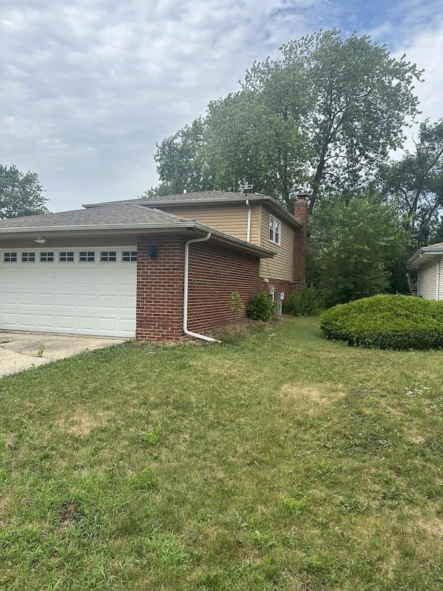 562 Willow Rd, Matteson, IL 60443 - view of side of home featuring an attached garage, brick siding, concrete driveway, a chimney, and a yard