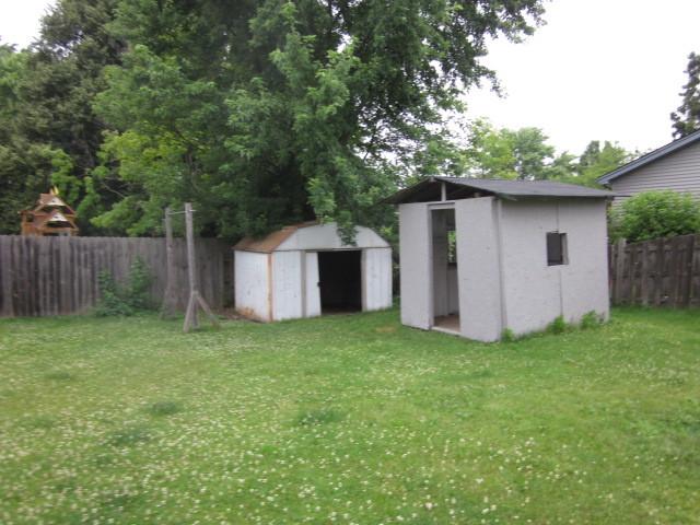 316 Brookwood Trl, Mchenry, IL 60050 - fenced backyard featuring a storage unit