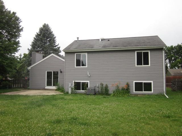 316 Brookwood Trl, Mchenry, IL 60050 - rear view of house with a patio, a lawn, and a chimney