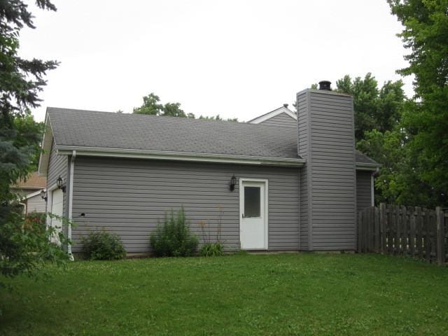 316 Brookwood Trl, Mchenry, IL 60050 - back of house featuring a chimney, an attached garage, and roof with shingles