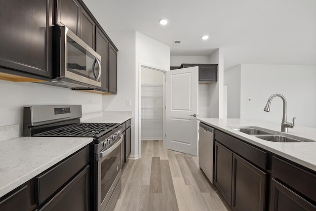 14628 S Azalia Cir, Plainfield, IL 60544 - kitchen featuring appliances with stainless steel finishes, light wood-style floors, light stone countertops, dark brown cabinets, and recessed lighting