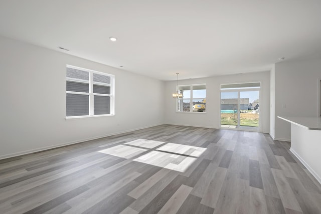 14628 S Azalia Cir, Plainfield, IL 60544 - unfurnished room with a chandelier, light wood-style floors, and recessed lighting