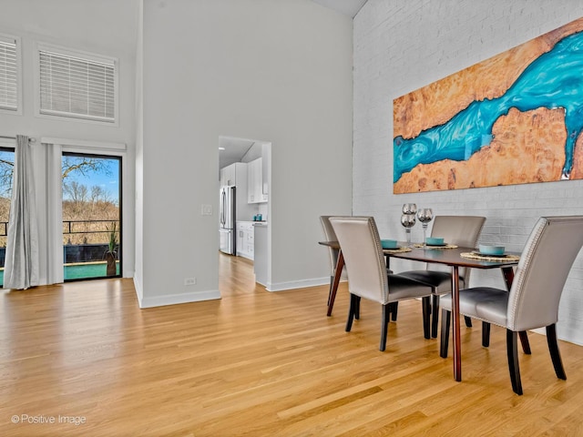 1039 Deerfield Pl Unit 1039, Highland Park, IL 60035 - dining space with a high ceiling and light wood-style flooring