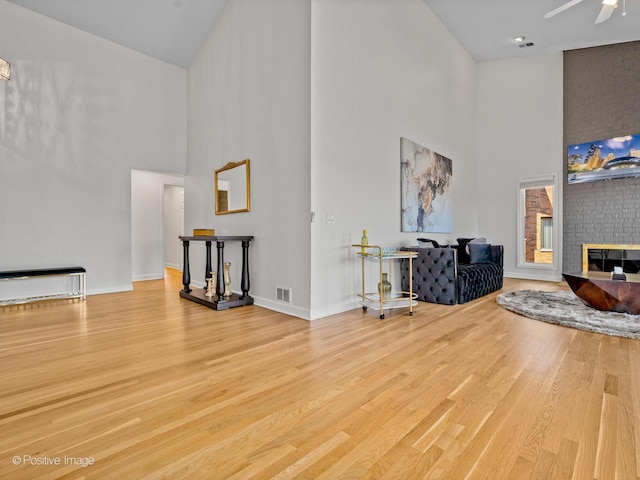 1039 Deerfield Pl Unit 1039, Highland Park, IL 60035 - living area with a high ceiling, wood finished floors, a fireplace, and ceiling fan