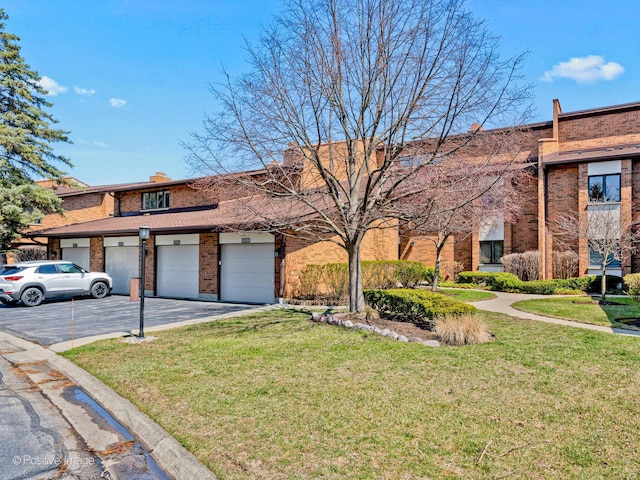 1039 Deerfield Pl Unit 1039, Highland Park, IL 60035 - view of front of property featuring brick siding, a front yard, driveway, and an attached garage