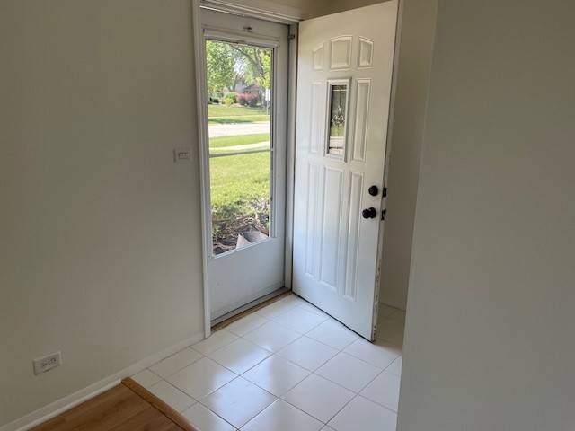 1040 Quanset Ct Unit 1804, Schaumburg, IL 60194 - doorway to outside featuring baseboards and light tile patterned floors