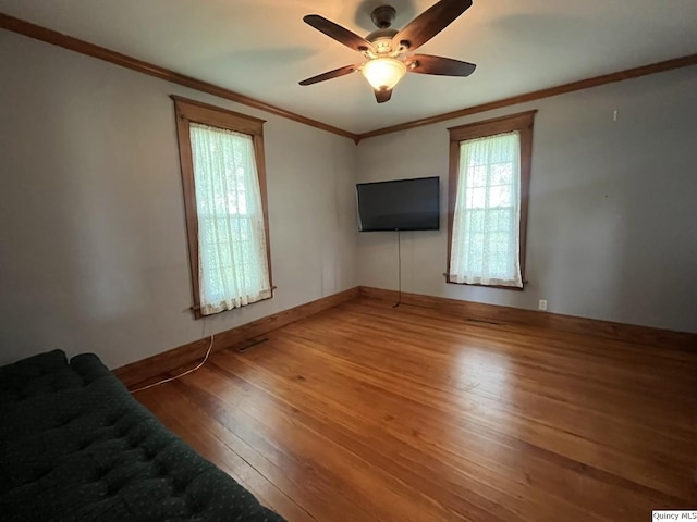 1550 N 2753rd Ln, Loraine, IL 62349 - unfurnished living room with hardwood / wood-style flooring, ceiling fan, and crown molding