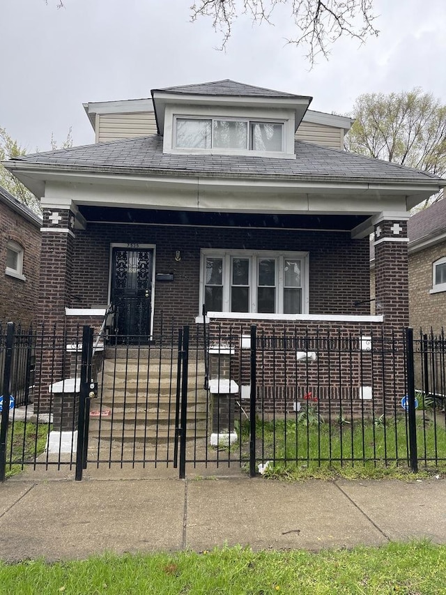 7535 S Vernon Ave, Chicago, IL 60619 - view of front of home featuring a porch, a fenced front yard, and brick siding