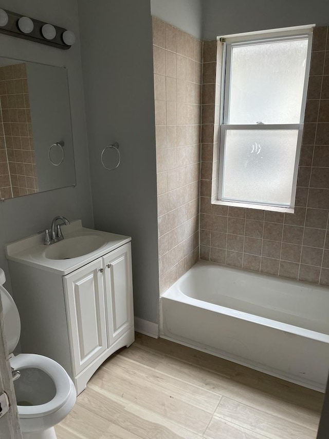 7535 S Vernon Ave, Chicago, IL 60619 - full bathroom featuring healthy amount of natural light, vanity, and wood finished floors