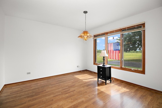947 Winter Park Dr Unit 947, New Lenox, IL 60451 - spare room with a chandelier and wood finished floors