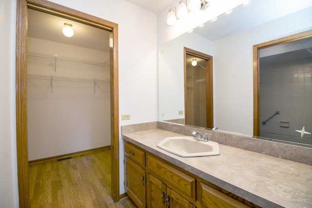 947 Winter Park Dr Unit 947, New Lenox, IL 60451 - bathroom featuring vanity, wood finished floors, and a spacious closet