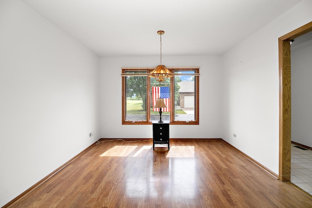 947 Winter Park Dr Unit 947, New Lenox, IL 60451 - unfurnished dining area with a chandelier and wood finished floors