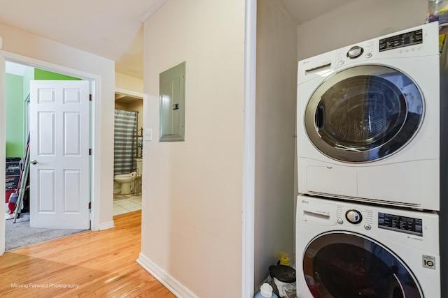 1423 E 68th St Unit 2, Chicago, IL 60637 - washroom featuring electric panel, estacked washer and dryer, and light wood-style floors