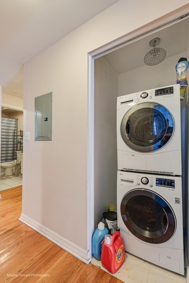 1423 E 68th St Unit 2, Chicago, IL 60637 - laundry area featuring electric panel, estacked washer and dryer, and light wood finished floors