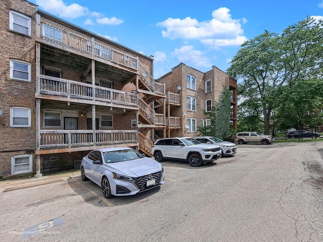 1423 E 68th St Unit 2, Chicago, IL 60637 - view of apartment building / complex featuring stairs and uncovered parking
