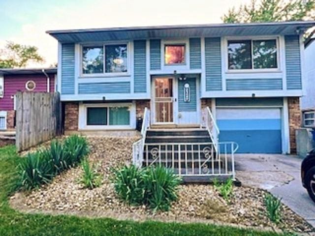 21546 Peterson Ave, Sauk Village, IL 60411 - raised ranch featuring an attached garage and concrete driveway
