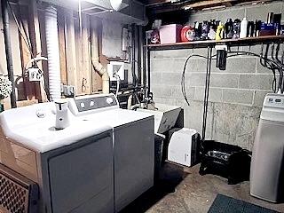 21546 Peterson Ave, Sauk Village, IL 60411 - laundry area with washer and dryer and concrete block wall