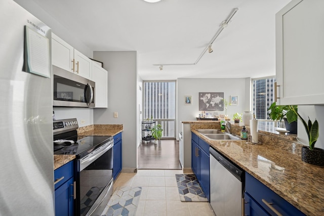222 N Columbus Dr Unit 3702, Chicago, IL 60601 - kitchen featuring stainless steel appliances, blue cabinets, white cabinetry, stone countertops, and light tile patterned floors