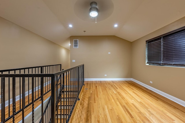 2012 W Coulter St, Chicago, IL 60608 - spare room with wood finished floors, a ceiling fan, vaulted ceiling, and recessed lighting