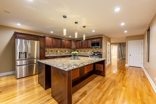 2012 W Coulter St, Chicago, IL 60608 - kitchen featuring appliances with stainless steel finishes, tasteful backsplash, light wood finished floors, recessed lighting, and light stone countertops