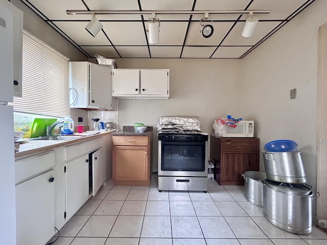 622 N Wisconsin Ave, Villa Park, IL 60181 - kitchen featuring stainless steel range with gas cooktop, white microwave, white cabinets, and light tile patterned floors