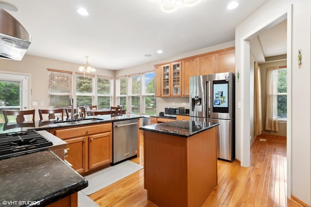 2701 Hamman Way, Aurora, IL 60502 - kitchen with appliances with stainless steel finishes, light wood-style floors, a center island, wall chimney range hood, and recessed lighting