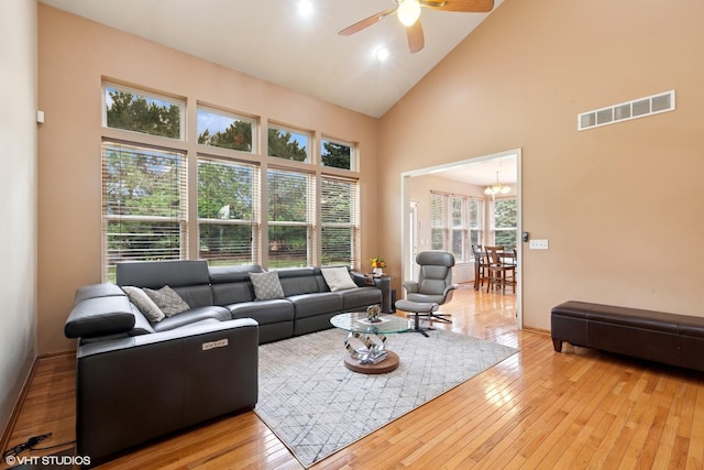2701 Hamman Way, Aurora, IL 60502 - living room featuring high vaulted ceiling, ceiling fan, wood-type flooring, and a chandelier