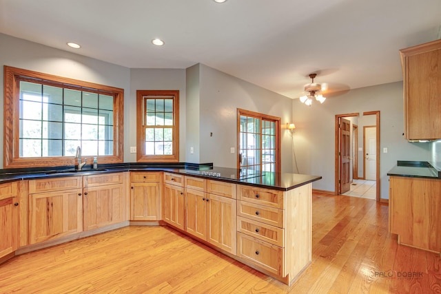 520 Holdridge Ave, Winthrop Harbor, IL 60096 - kitchen featuring light brown cabinets, a peninsula, dark countertops, light wood-style flooring, and recessed lighting