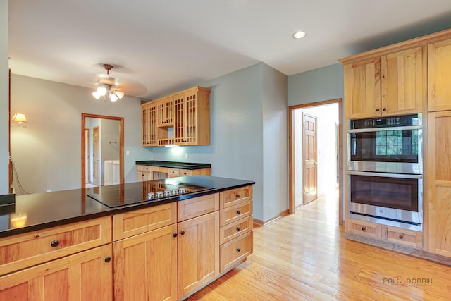520 Holdridge Ave, Winthrop Harbor, IL 60096 - kitchen with stainless steel double oven, dark countertops, light brown cabinetry, light wood-type flooring, and glass insert cabinets
