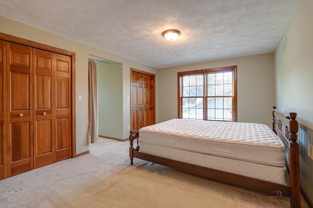 520 Holdridge Ave, Winthrop Harbor, IL 60096 - bedroom featuring light colored carpet and two closets