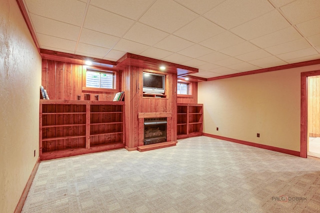 520 Holdridge Ave, Winthrop Harbor, IL 60096 - unfurnished living room with carpet flooring, a fireplace with raised hearth, plenty of natural light, a textured wall, and wooden walls