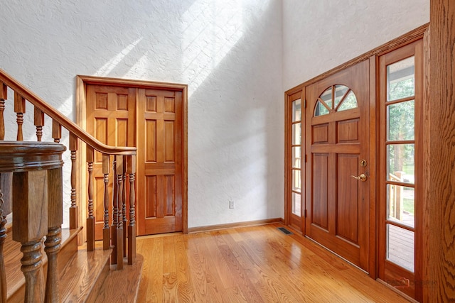 520 Holdridge Ave, Winthrop Harbor, IL 60096 - entrance foyer with a textured wall, light wood finished floors, and stairs