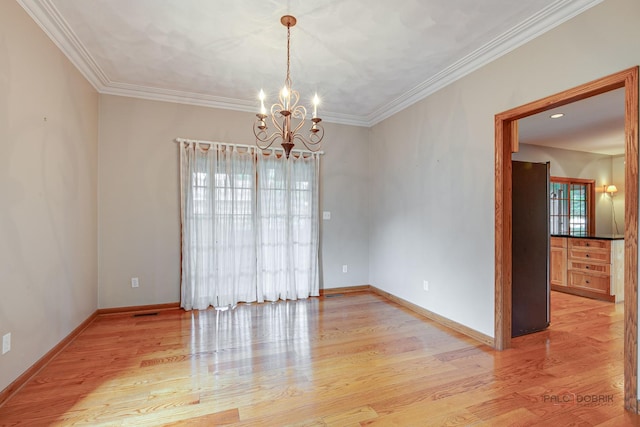 520 Holdridge Ave, Winthrop Harbor, IL 60096 - spare room featuring a chandelier, light wood-style flooring, and crown molding