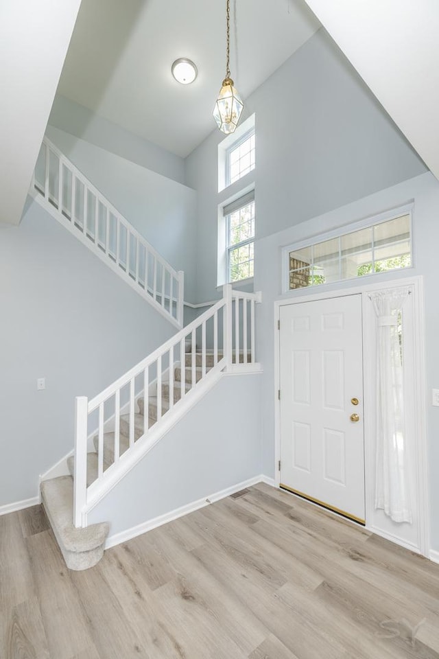 1114 Georgetown Way, Vernon Hills, IL 60061 - entrance foyer featuring a towering ceiling, stairs, and wood finished floors