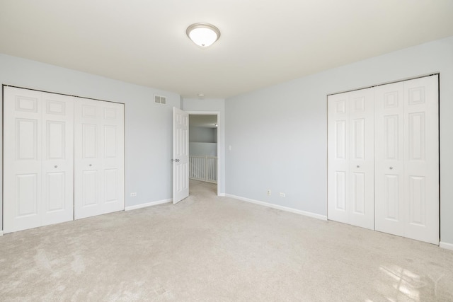 1114 Georgetown Way, Vernon Hills, IL 60061 - unfurnished bedroom with carpet floors and two closets