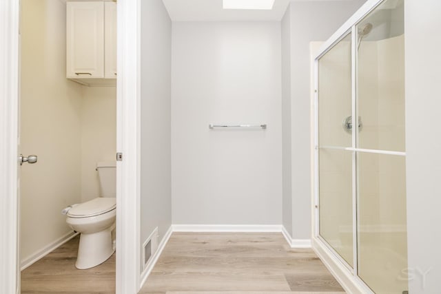 1114 Georgetown Way, Vernon Hills, IL 60061 - bathroom featuring a stall shower, wood finished floors, and a skylight
