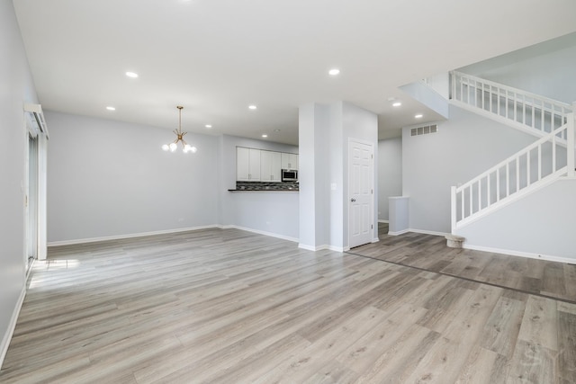 1114 Georgetown Way, Vernon Hills, IL 60061 - unfurnished living room featuring stairs, a chandelier, recessed lighting, and light wood-style flooring