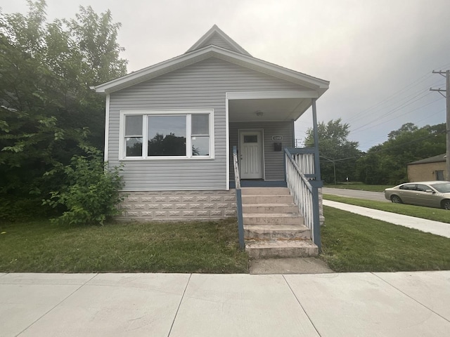 12200 S Lowe Ave, Chicago, IL 60628 - view of front facade featuring a porch and a front lawn