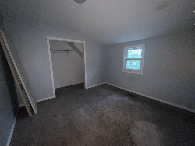 12200 S Lowe Ave, Chicago, IL 60628 - unfurnished bedroom featuring vaulted ceiling, dark colored carpet, and a closet