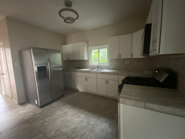12200 S Lowe Ave, Chicago, IL 60628 - kitchen featuring stainless steel refrigerator with ice dispenser, backsplash, tile countertops, stove, and white cabinets