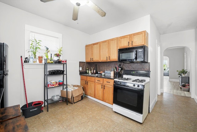 1637 N Keeler Ave, Chicago, IL 60639 - kitchen featuring arched walkways, gas range, black microwave, backsplash, and ceiling fan