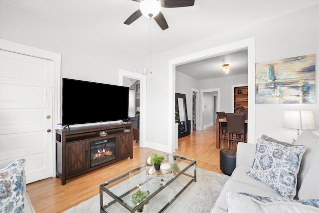 1637 N Keeler Ave, Chicago, IL 60639 - living area featuring light wood-style floors, ceiling fan, and a glass covered fireplace