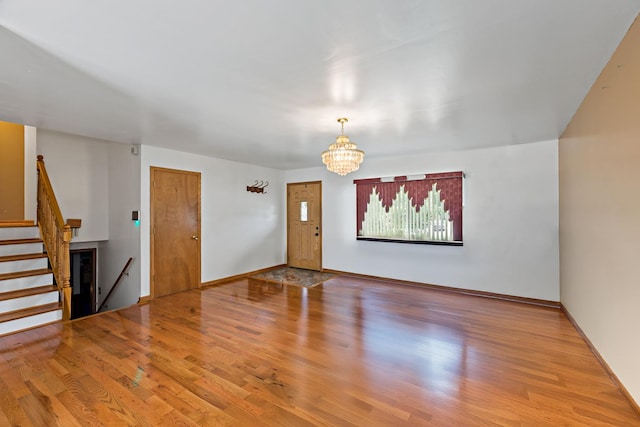 3513 Bordeaux Ct, Hazel Crest, IL 60429 - unfurnished living room featuring wood finished floors, a chandelier, and stairs