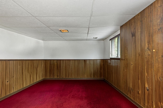 3513 Bordeaux Ct, Hazel Crest, IL 60429 - empty room with wooden walls, dark carpet, a paneled ceiling, and a wainscoted wall