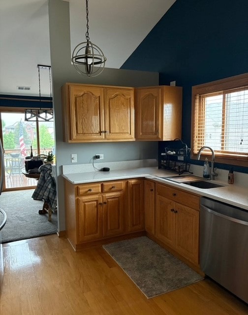 8310 Auburn Ln, Frankfort, IL 60423 - kitchen with a chandelier, light countertops, stainless steel dishwasher, light wood-style flooring, and high vaulted ceiling